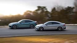 BMW i4 xDrive40 Gran Coupe, Mercedes CLA 350 EQ, Elektroauto, Limousine, Straße, Vergleichstest, Fahrdynamik, Allradantrieb, Mittelklasse, Automobil Zwei viertürige Limousinen, BMW i4 xDrive40 Gran Coupe und Mercedes CLA 350 EQ, fahren auf einer Landstraße.