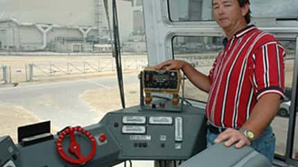 Bob Myers, a crawler systems engineer with United Space Alliance, stands beside the driver's console inside a Crawler-Transporter cab. Credit: NASA/KSC Bob Myers, a crawler systems engineer with United Space Alliance, stands beside the driver's console inside a Crawler-Transporter cab. Credit: NASA/KSC