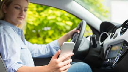 Using Phone,Text Messaging,Distracted,Vehicle Interior,Women,Females,Careless,Sending,20-29 Years,18-19 Years,Teenager,Writing,Reading,Driving,Traffic,One Person,Communication,On The Move,Danger,Risk,Technology,Horizontal,People,Road,Mobile Phone,Telephone,Car,Steering Wheel Woman In Car Texting On Mobile Phone Whilst Driving