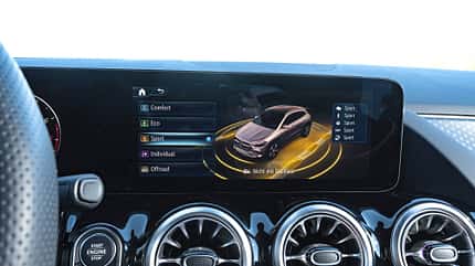 Das Bild zeigt das digitale Cockpit eines Mercedes GLA250 4Matic mit Anzeige der Fahrmodi auf dem zentralen Display. Zu sehen sind die Auswahlmöglichkeiten Comfort, Eco, Sport, Individual und Offroad sowie eine 3D-Visualisierung des Fahrzeugs.