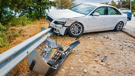 Crashed car with deflated airbags after accident finished on road crashed barrier