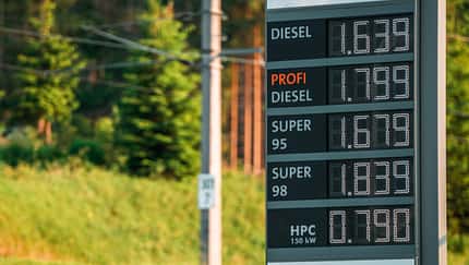 Fuel Prices Displayed on a Signpost in a Rural Area During the Day