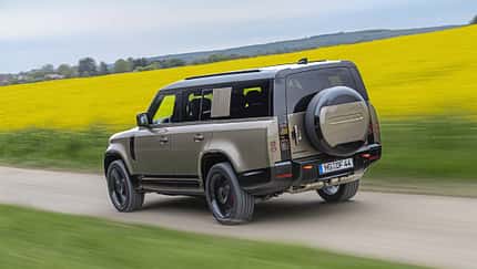 Land Rover Defender 130 D250, SUV, Geländewagen, Allradantrieb, Offroad, Land Rover, 2024, Rapsfeld, Straßenfahrt, Automobil Land Rover Defender 130 D250 fährt auf einer Landstraße an einem blühenden Rapsfeld vorbei.